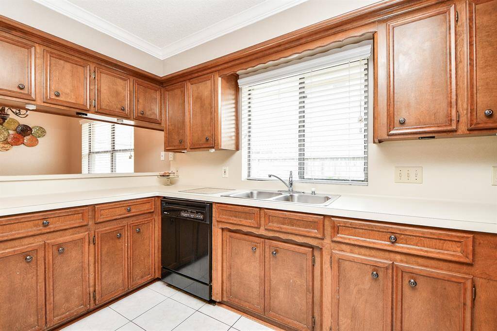 Spacious kitchen with ample cabinetry, bright natural light, and a convenient layout perfect for cooking and entertaining.