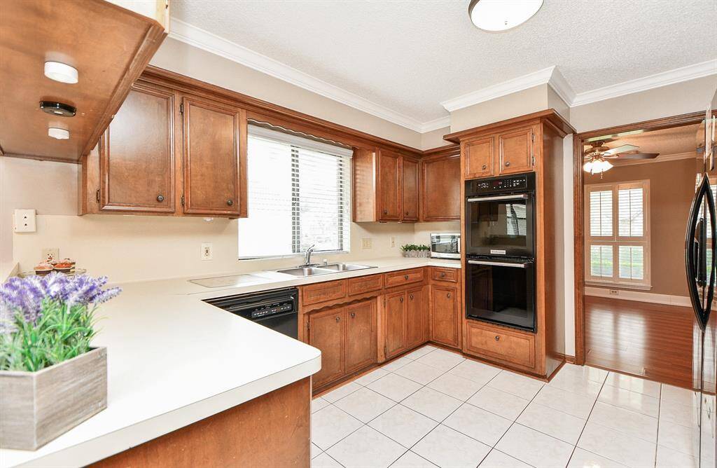 Warm and inviting kitchen featuring rich wood cabinetry, modern appliances, and ample natural light—perfect for cooking and entertaining.