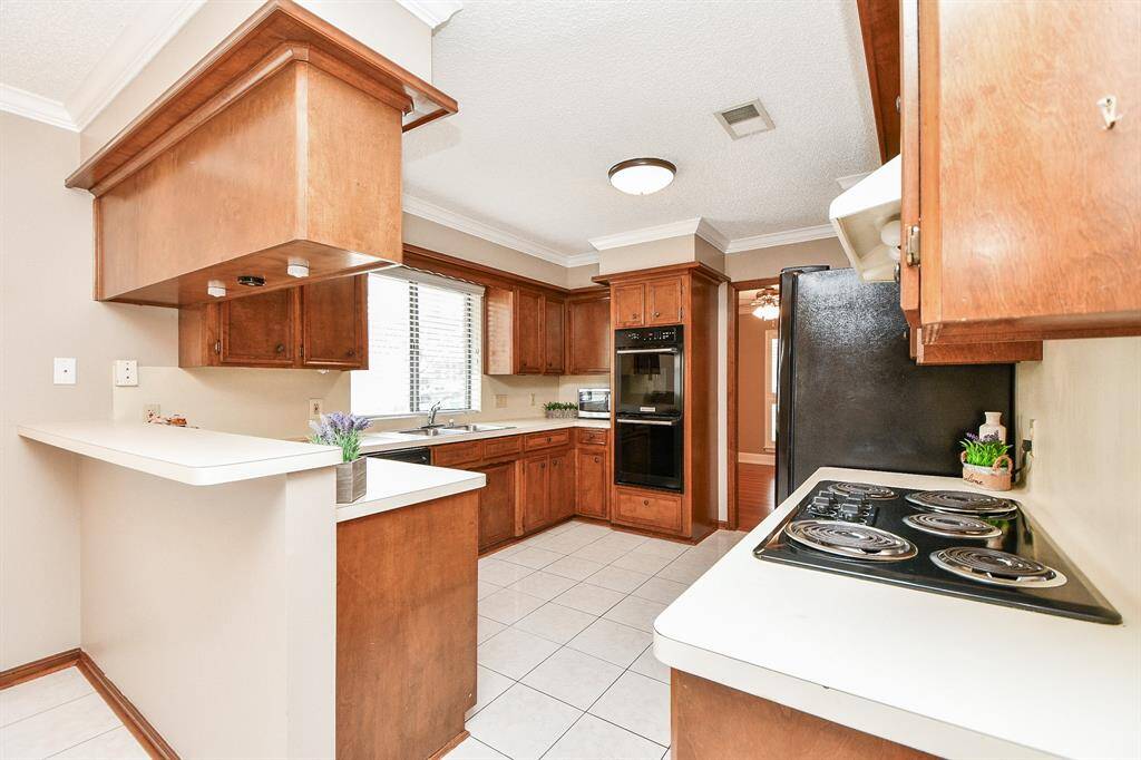 Spacious kitchen with modern appliances and ample cabinetry, perfect for culinary enthusiasts.