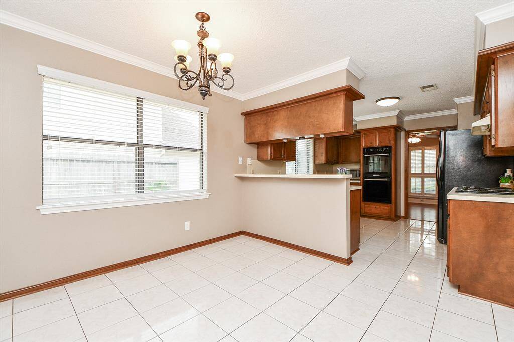 Breakfast room off kitchen with chandelier & large picture window