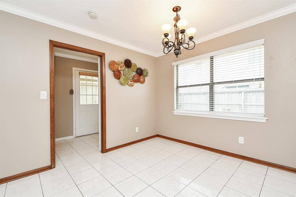 Bright breakfast nook with stylish chandelier and ample natural light.