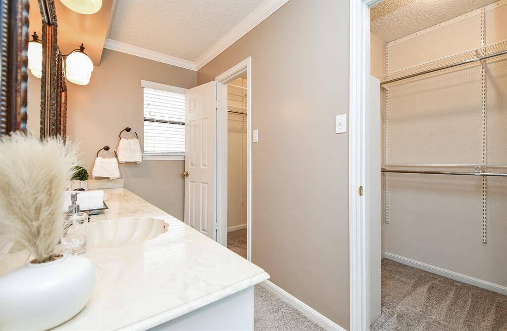 Spacious primary bath with expansive walk-in closets.