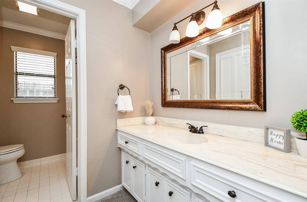 Elegant secondary bathroom with a stylish vanity.