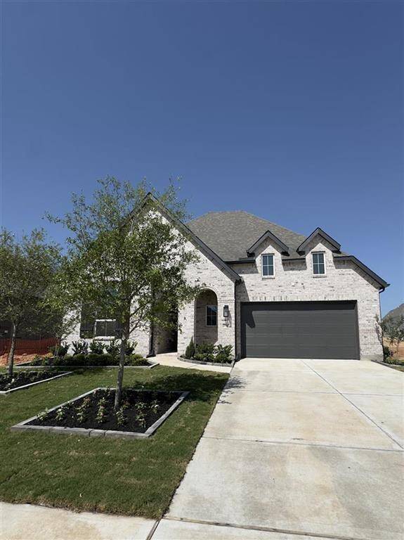 HOME IN PROGRESS - Stunning model floorplan with enhanced landscaping and stunning light-colored brick for standout curb appeal!