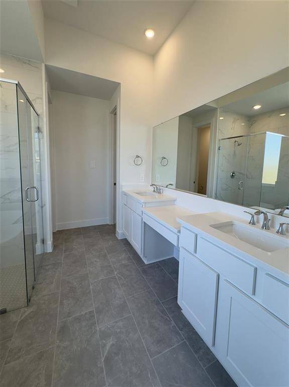 HOME IN PROGRESS - Ensuite primary bathroom with dual vanities, a soaking tub, and a separate walk-in shower for a spa-like retreat!