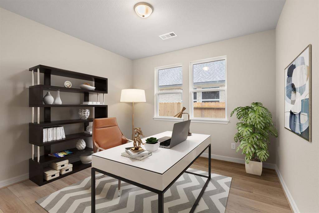 The home office features French doors, beautiful floors, large windows that give a fresh feel, this space promotes focus and creativity. Photo is virtually staged