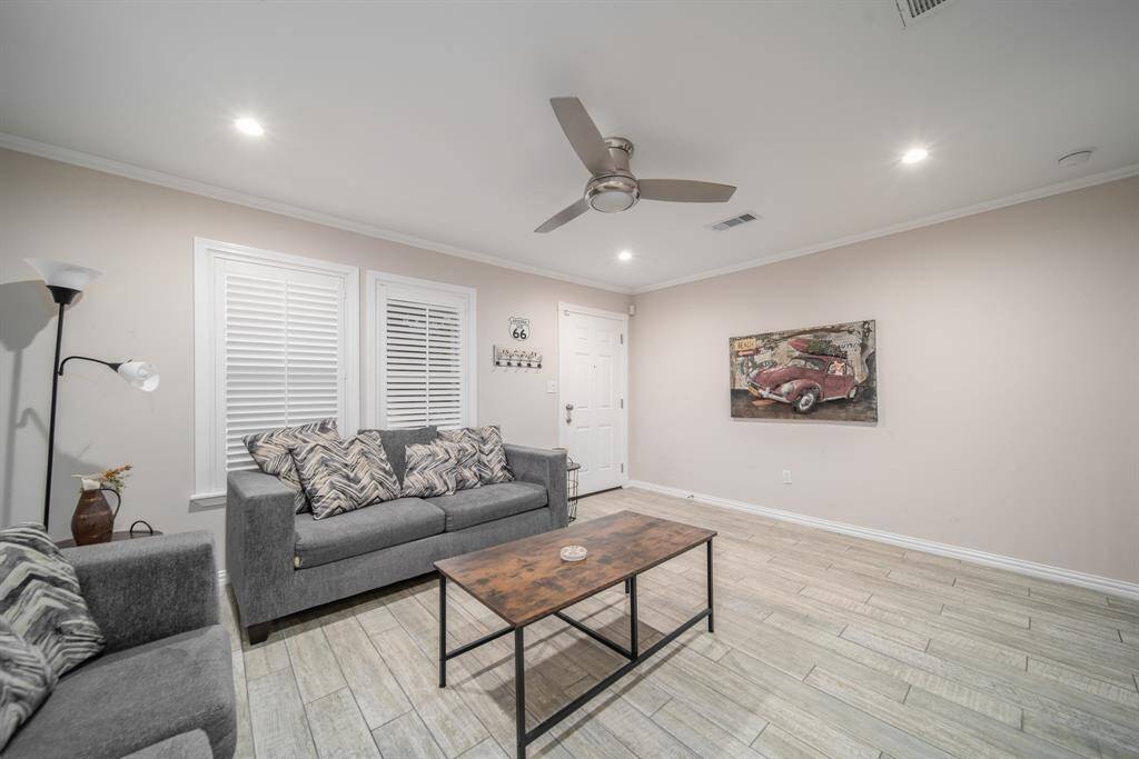 Resting under a high ceiling accented by recessed lighting and Crown molding, the family room offers a comfortable spot to relax and unwind. Note the beautifully framed windows with plantation shutters.
