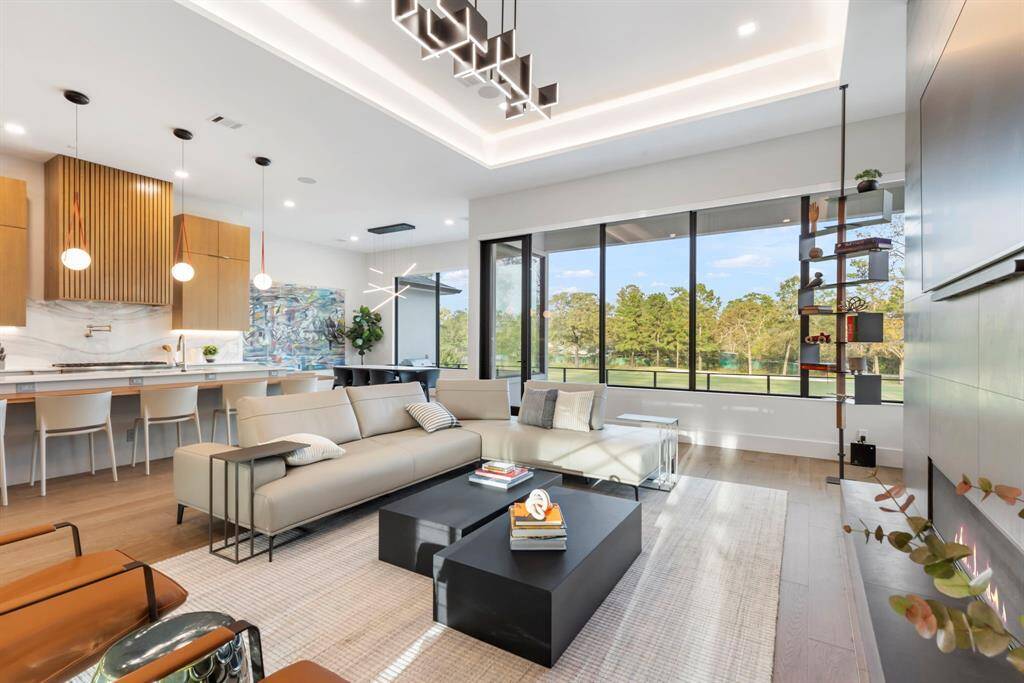 View of the open concept living room next to the kitchen and dining area with 12' ceilings.