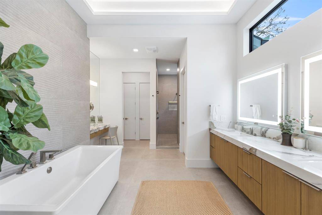 The primary bathroom has two toilets, a dual vanity sink, a large 72-inch soaking tub, and cove lighting.  Radiant heat floors will warm your feet during colder days.