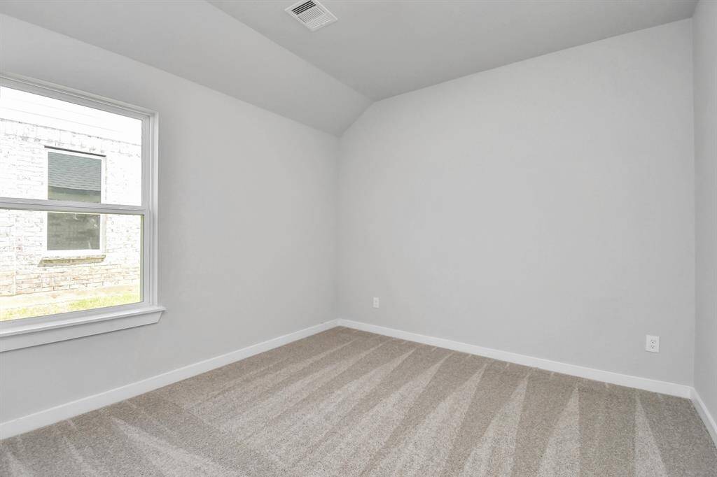 Generously sized secondary bedrooms featuring spacious closets, soft and inviting carpeting underfoot, large windows allowing plenty of natural light. Sample photo of completed home. As-built color and selections may vary.