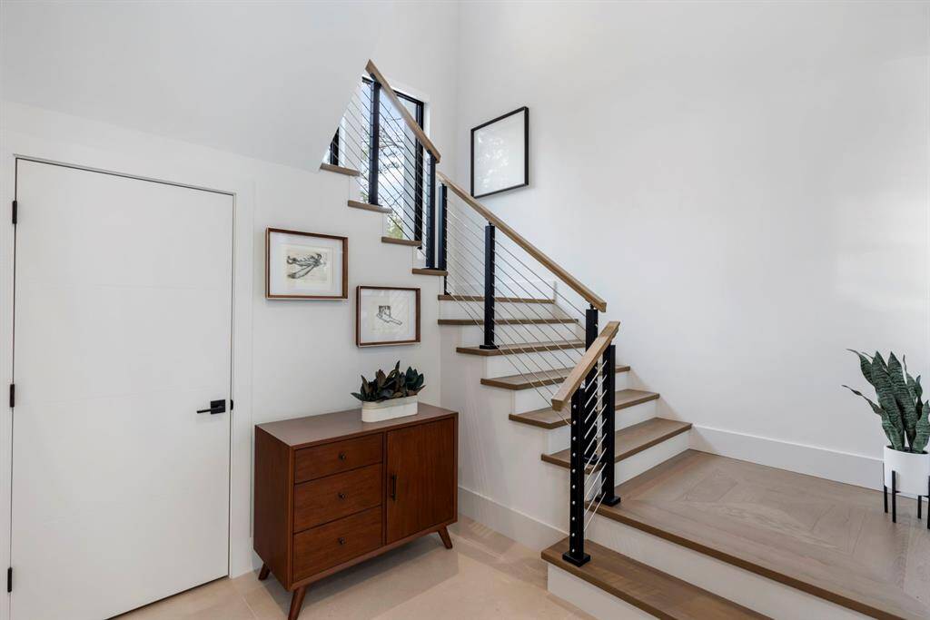 The 54" wide wood tread staircase leads to the second floor.  The coat closet on the left also has a rack for the entire home AV equipment.