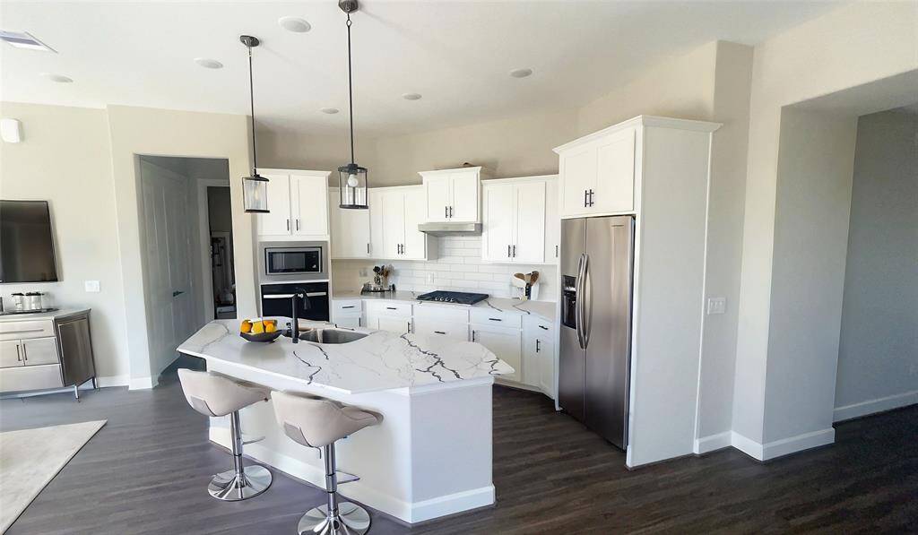 Indulge in elegance where the dining area seamlessly lends sophistication and comfort. With ample space, stunning finishes, and a warm ambiance, it provides intimate dinners and festive gatherings. *Image depicts similar floor plan in the community and is virtually staged.