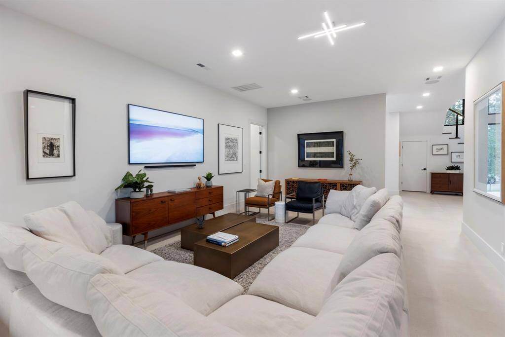 View of the downstairs family/game room which is located behind the front vestibule.  A new powder bath was added around the corner on the right.