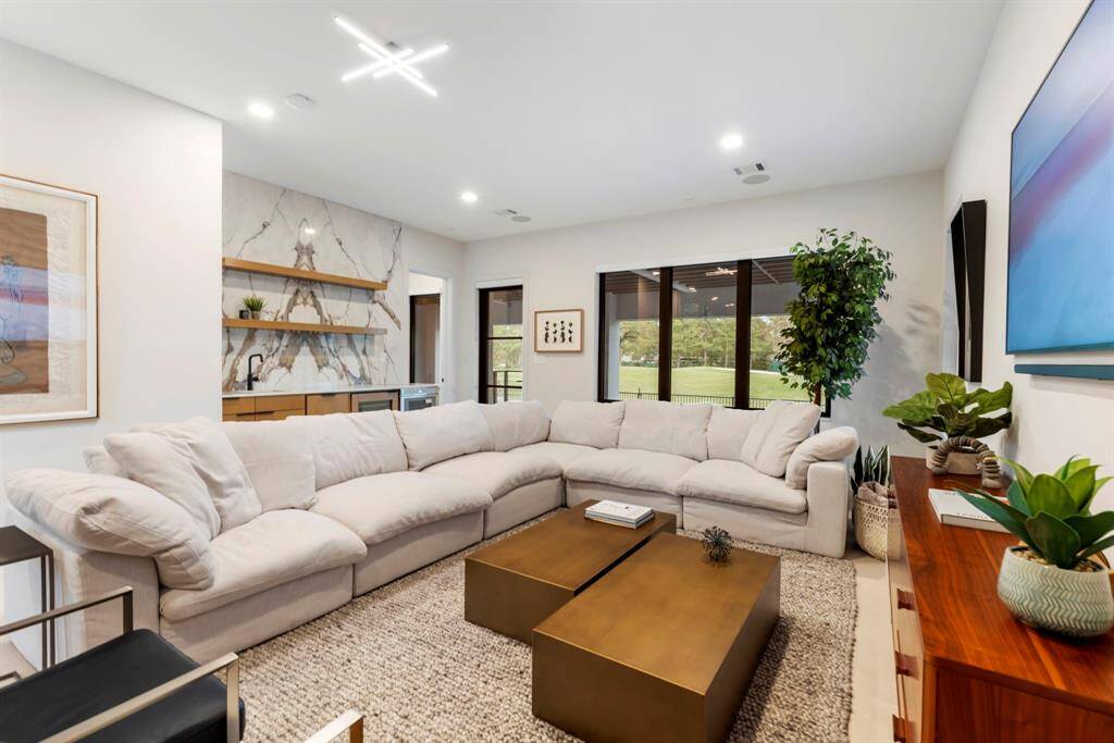 A view of the downstairs family/gameroom which offers pool and golf course views.