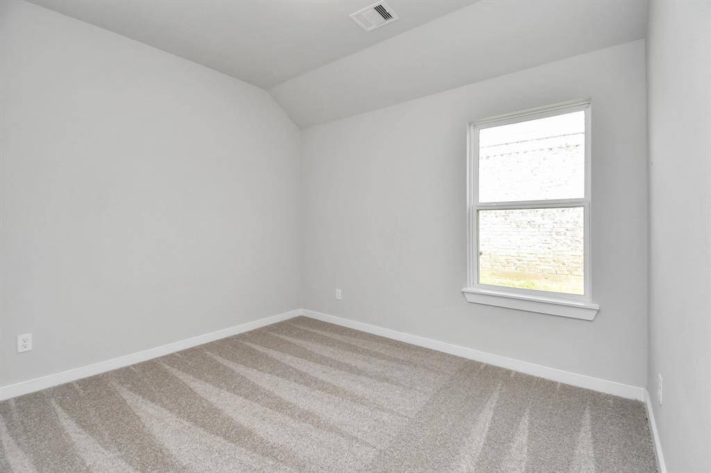 Generously sized secondary bedrooms featuring spacious closets, soft and inviting carpeting underfoot, large windows allowing plenty of natural light. Sample photo of completed home. As-built color and selections may vary.