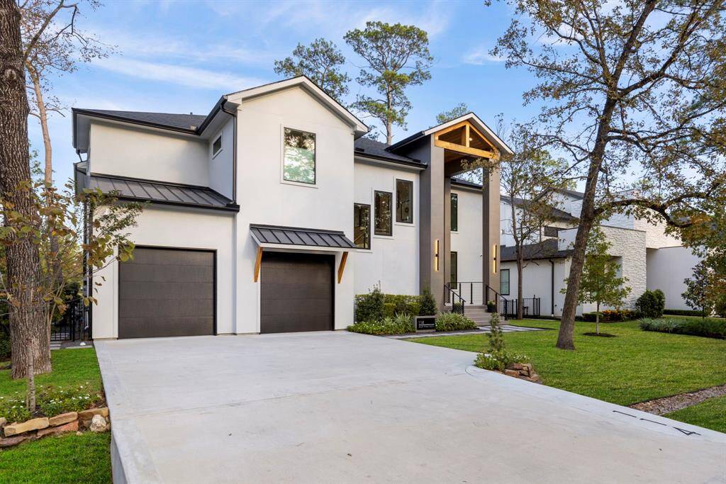 View of the front driveway with walkway to the front covered porch.  The front door faces west.