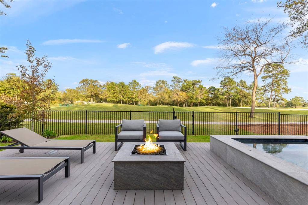 View of the poolside 48" x 48" fire pit with ample seating space.