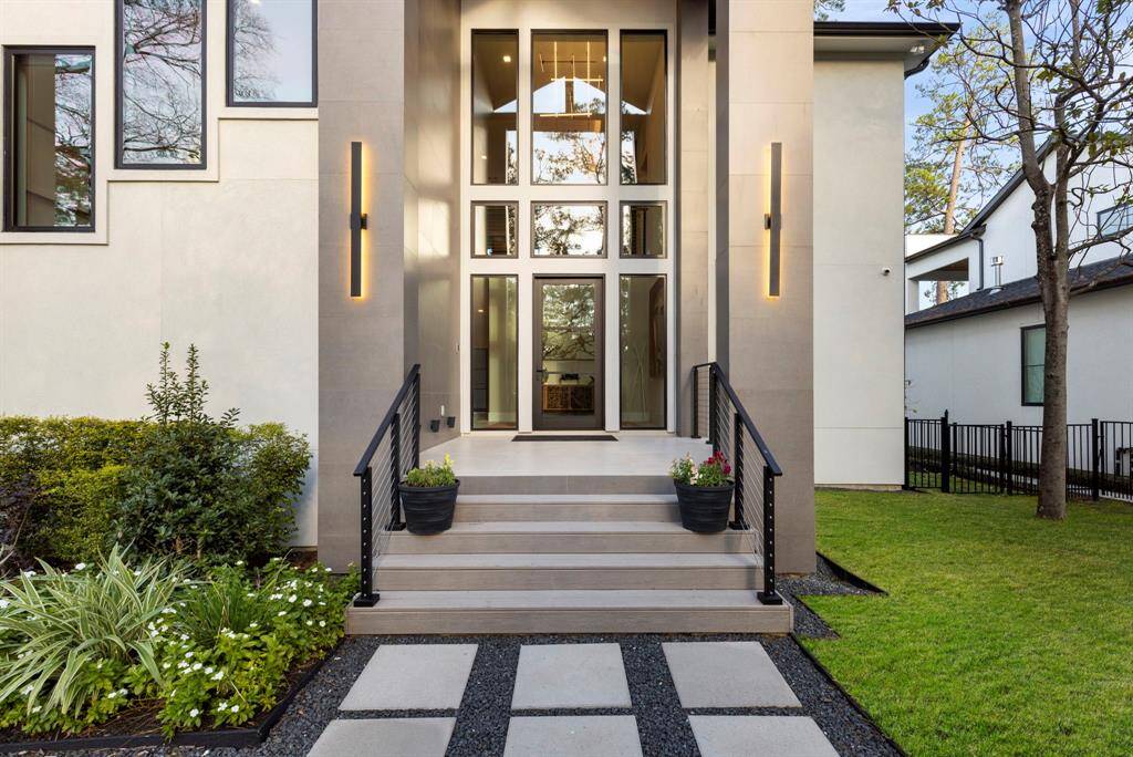 This striking two-story exterior elevation has a  12' x 12' tile covered porch with cedar planked ceiling with cedar beams, large windows and 45" wide door, offering a welcoming and stylish first impression.
