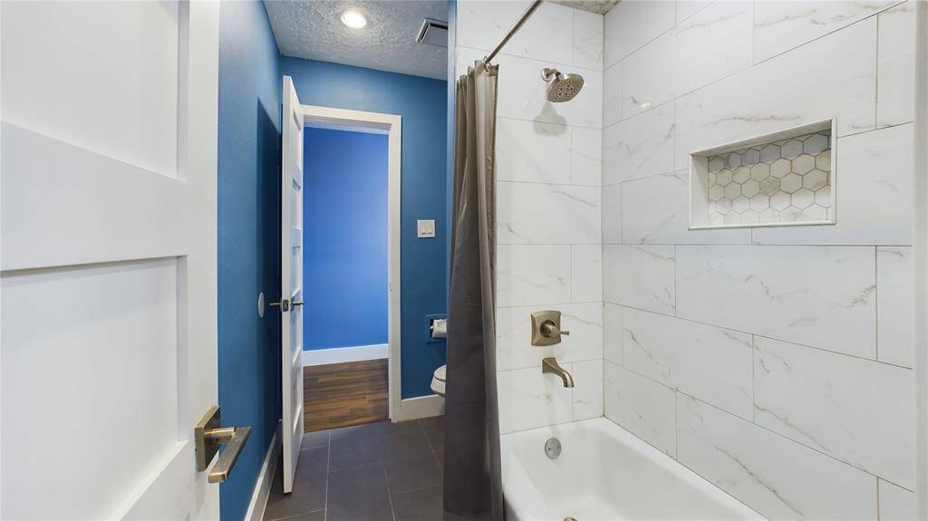 Jack N Jill Style tub and shower Italian Quartz and toilet, doors to create privacy between rooms.