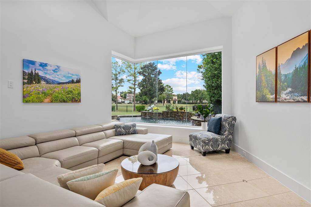 This modern room offers a beautiful view of the backyard and ample space for comfort, providing versatile potential for use as a gym, game room, or any other area to suit your needs.