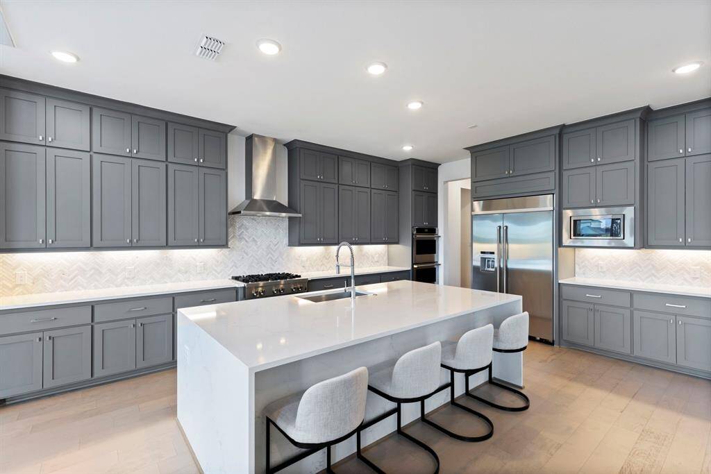 With upgraded quartz countertops and a beautiful waterfall island breakfast bar.