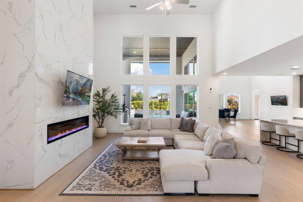Upgraded floor to ceiling tiled wall with electric fireplace.