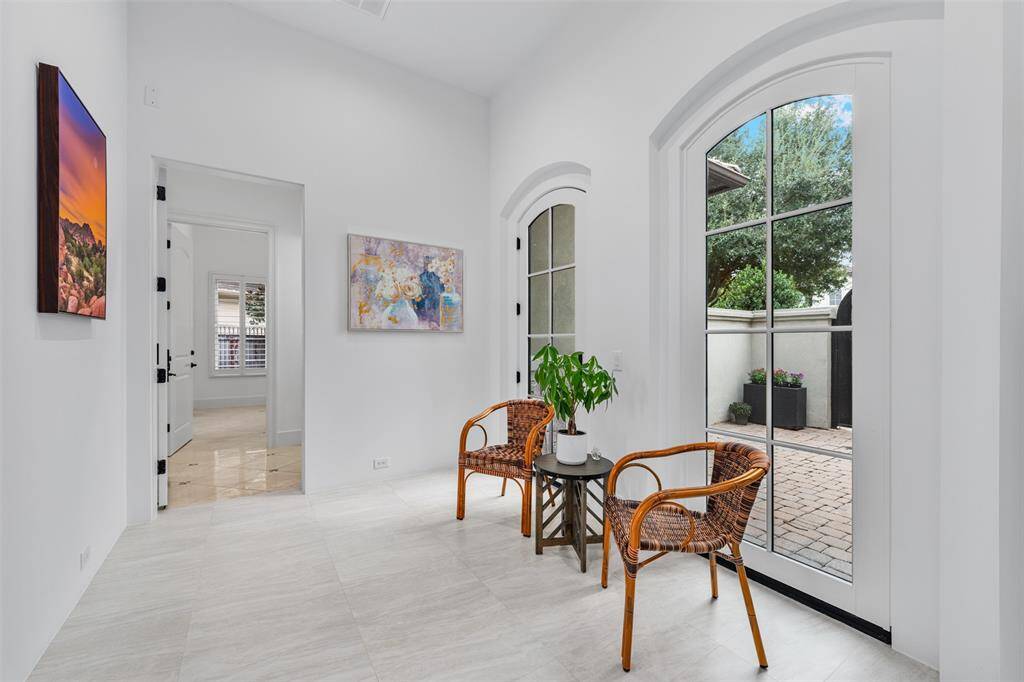 A hallway provides access to the patio and front yard, offering an ideal space for gardening or enjoying outdoor activities in a serene setting.