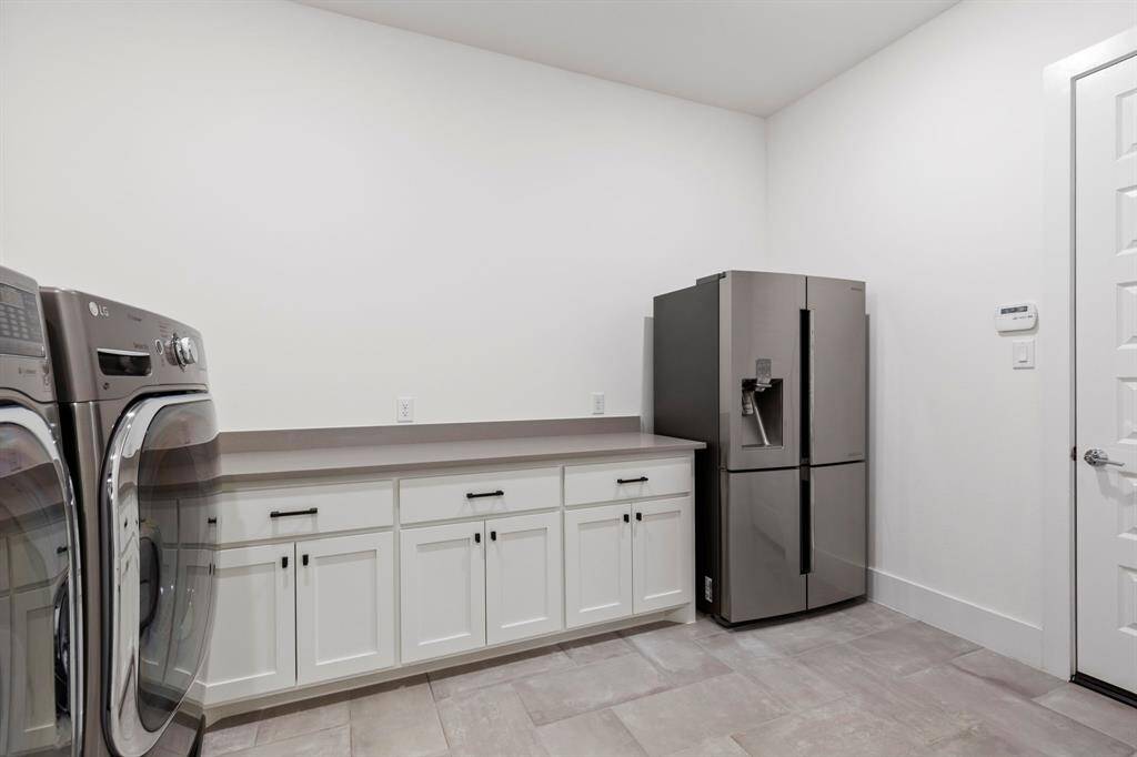 Additional space in utility room for additional refrigerator and extra storage.
