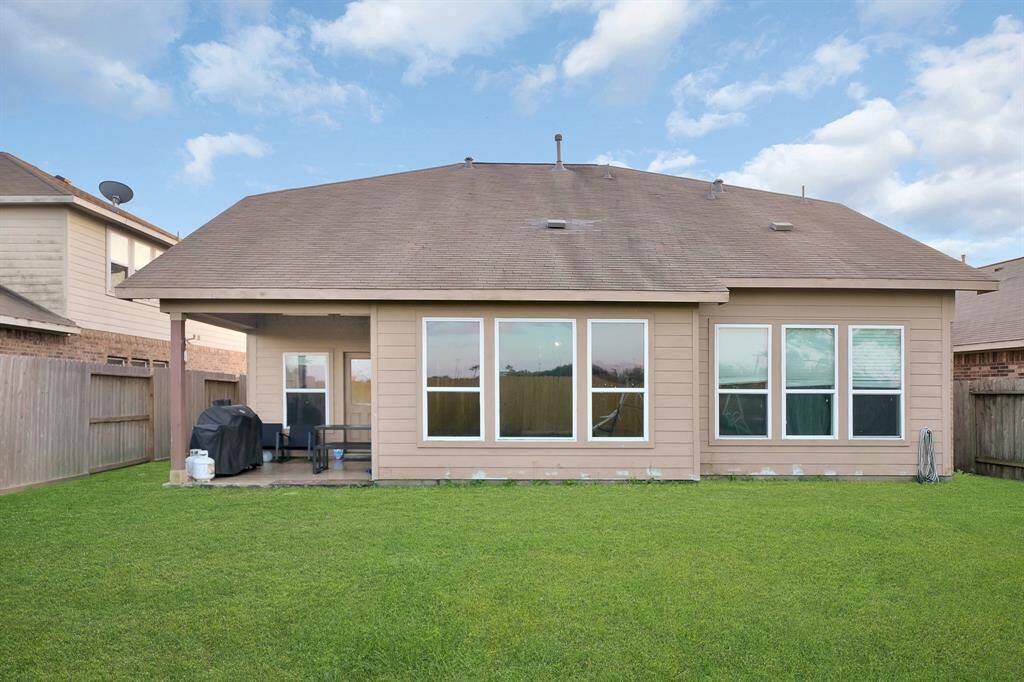 View of the back of the home from the large backyard perfect for kids or entertaining.