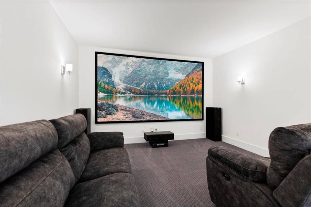 second story media room with projector and screen.