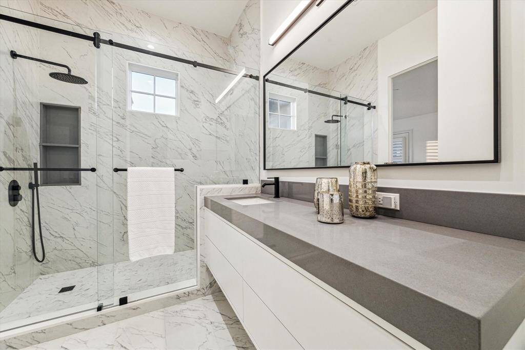 This luxurious home features six full bathrooms and one half bathroom; designed with spacious shower rooms, sinks, and large countertops for added comfort and convenience.
