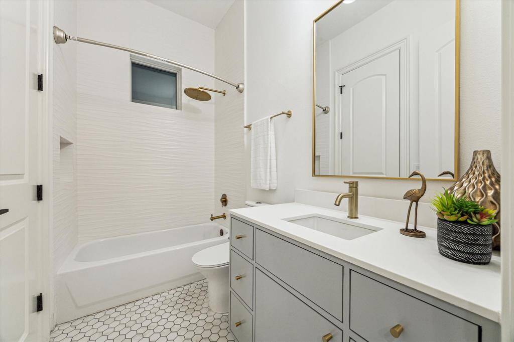 This luxurious home features six full bathrooms and one half bathroom; designed with shower/tub combo, sinks, and white countertops.