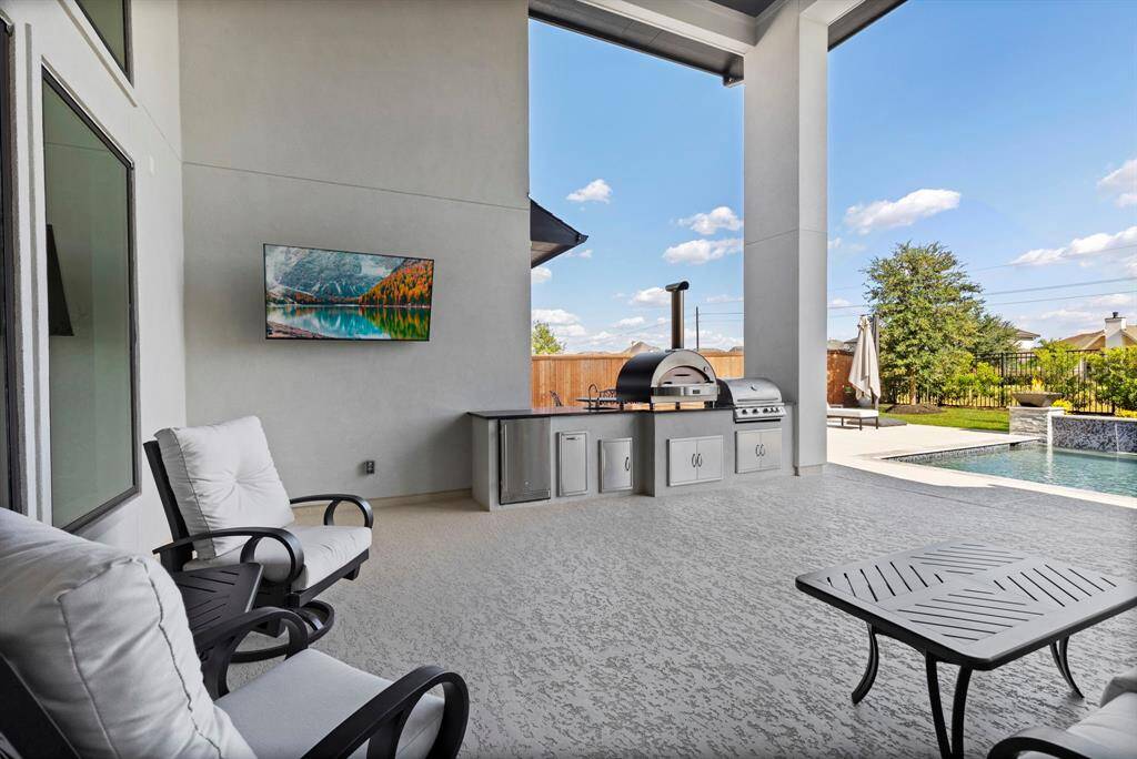 Oversized patio with summer full summer kitchen.