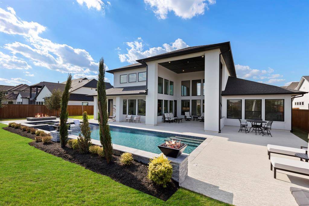 Chlorine PebbleTec heated pool with water feature and fire bowls.
