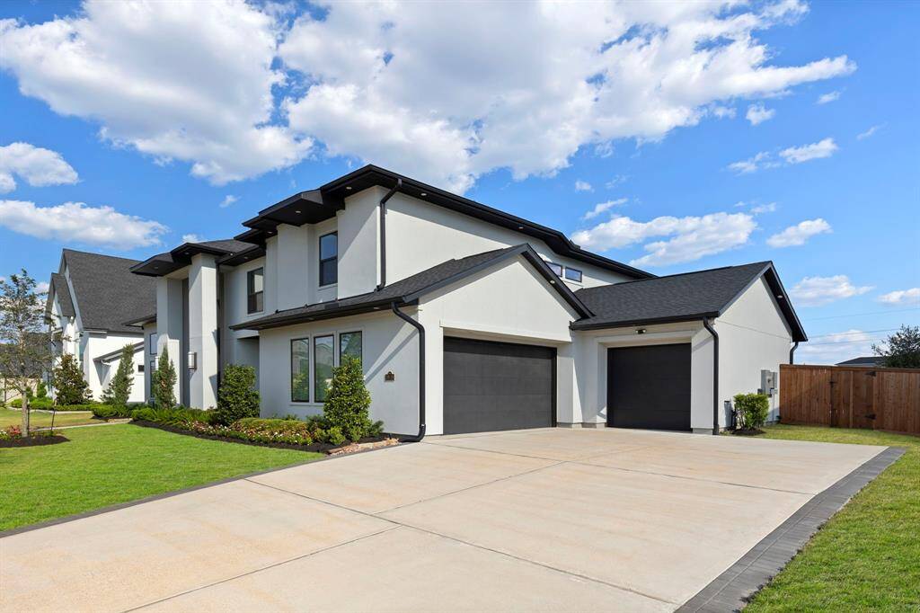 Three Car garage with epoxy floors and a double wide driveway.