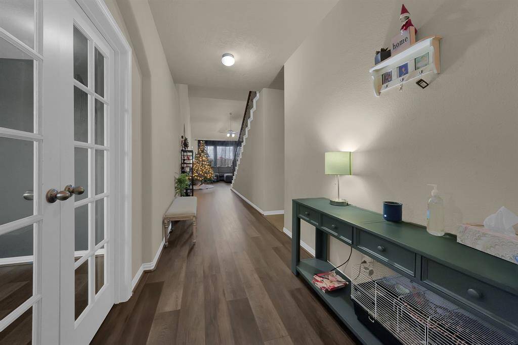 Beautiful entry way with extended hallway and a view of the living room which offers an abundance of natural lighting.