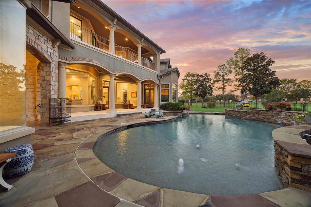 The patio boasts a gorgeous view of the pool, providing a serene backdrop for relaxation and outdoor activities.