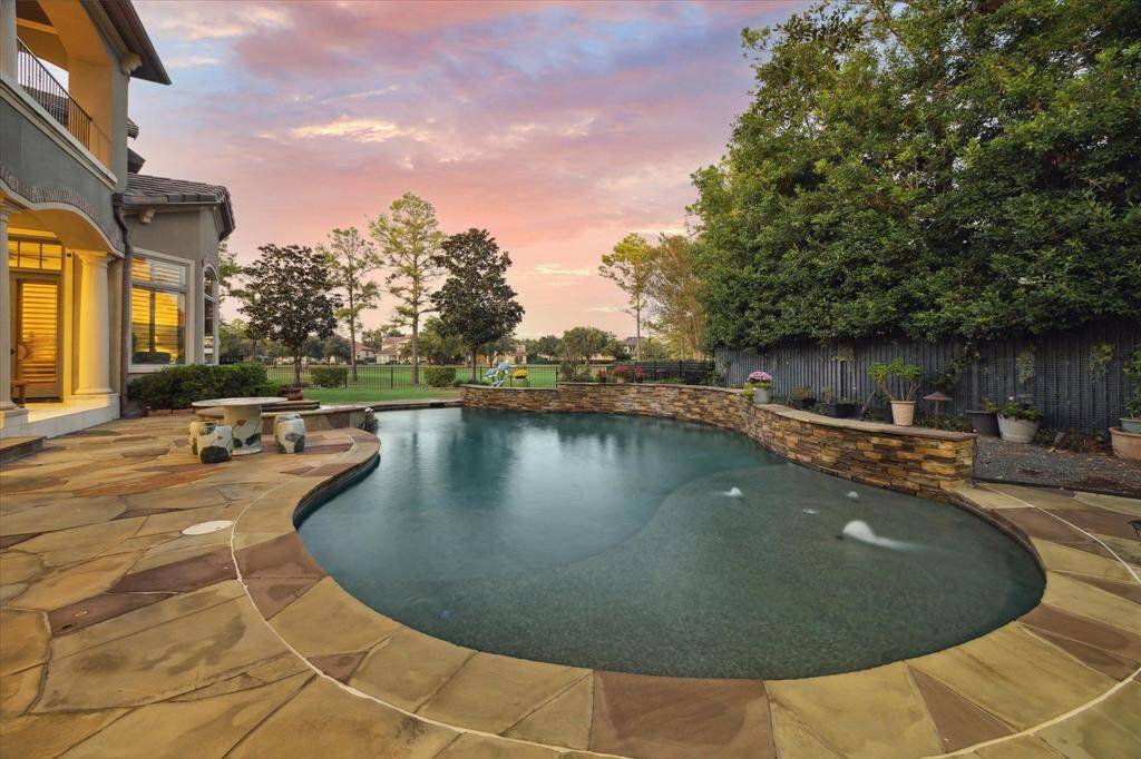The patio boasts a gorgeous view of the pool, providing a serene backdrop for relaxation and outdoor activities.