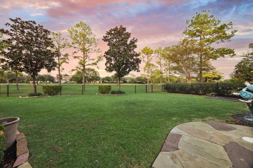 The backyard features spacious greenery with expansive views of the golf course, creating a picturesque setting for outdoor activities and relaxation.
