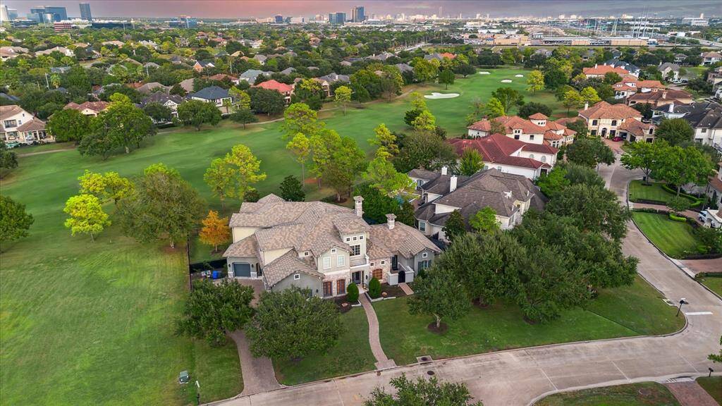 The aerial view showcases a beautiful golf course and highlights the home's location in a friendly, family-oriented neighborhood, perfect for creating lasting memories.