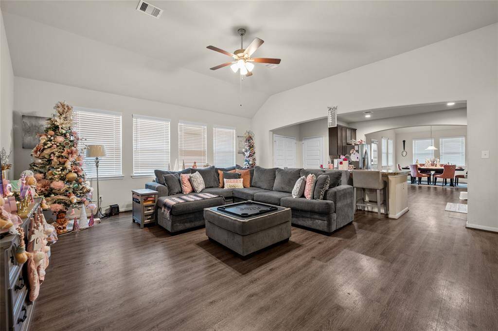 A spacious, airy living area with high ceilings, natural light, and seamless flow exudes comfort and elegance.
