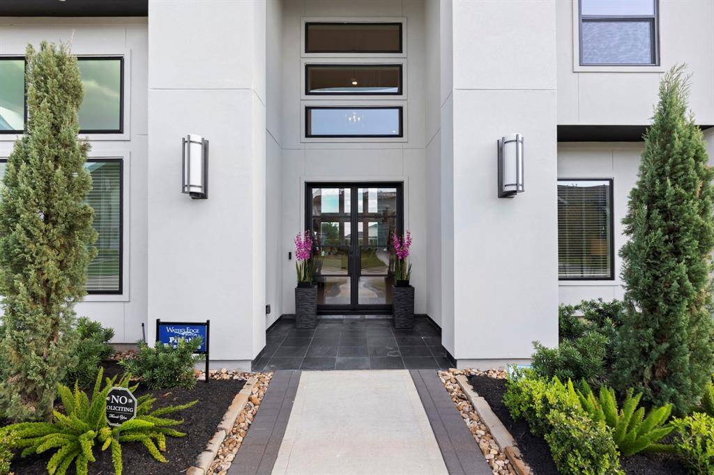 Iron double doors that lead into a well maintained home with endless upgrades.