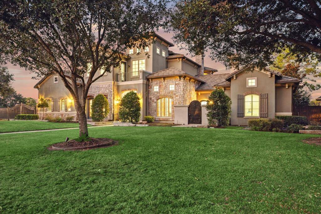 This stunning luxury home boasts a beautifully landscaped front yard with abundant greenery, perfect for gardening enthusiasts, and complements its elegant architecture for a captivating first impression.