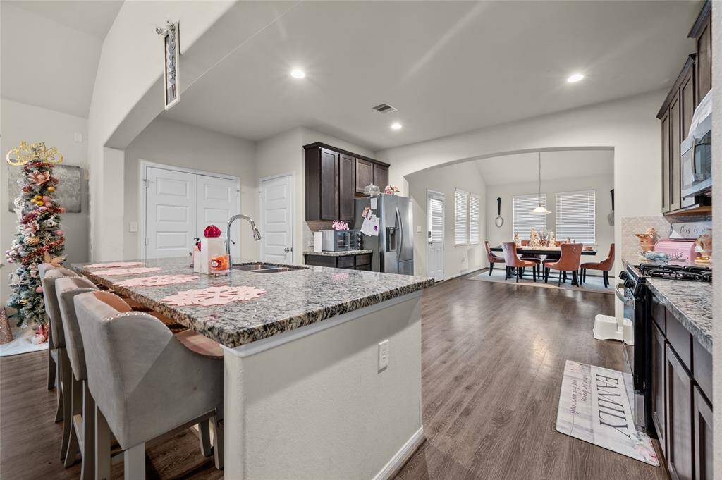 The spacious kitchen featuring a breakfast bar.