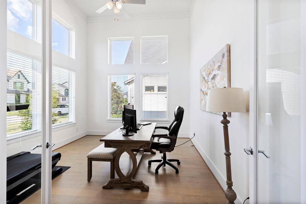 Office ready for a productive day.  High ceilings and double glass doors makes this space feel ight and airy.