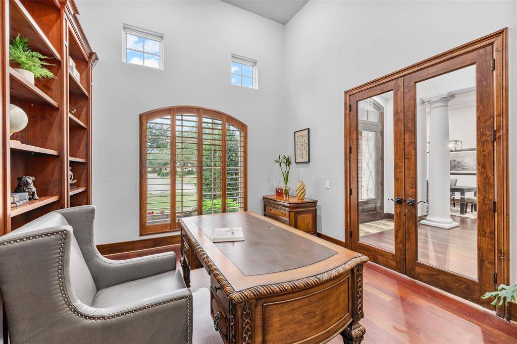 The office boasts rich wood finishes and built-in shelves, creating a warm and inviting space that is perfect for focusing and working from the comfort of home.