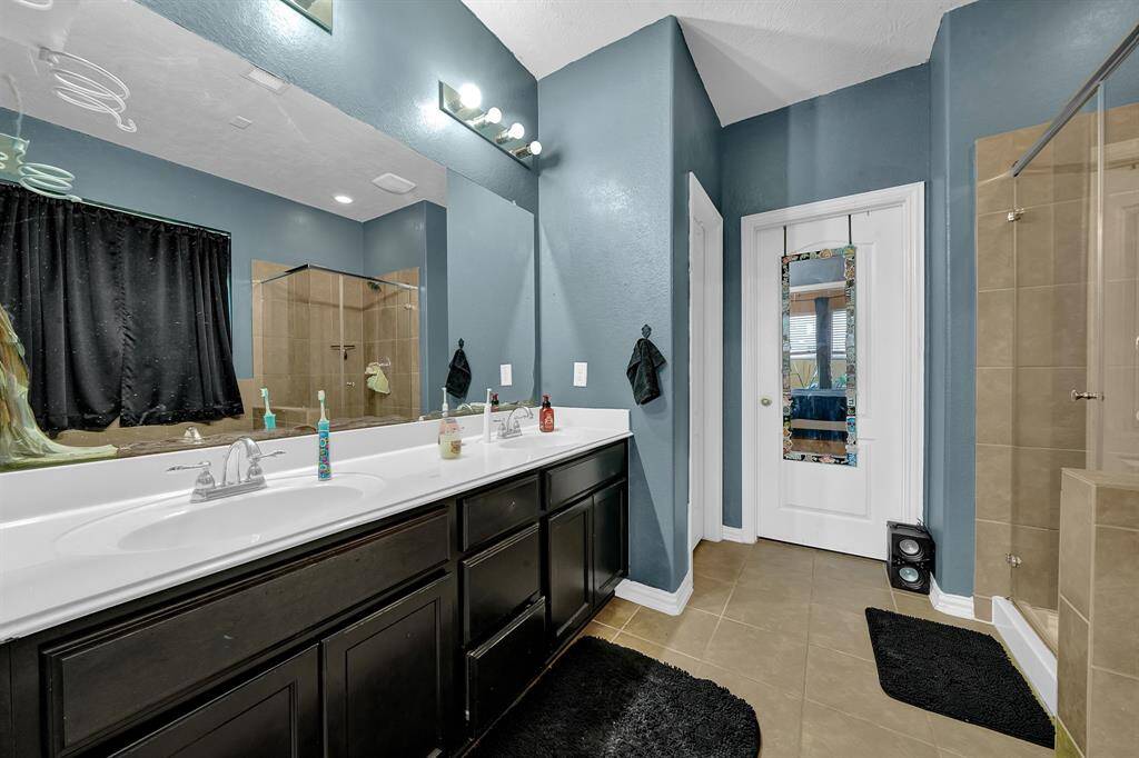 Primary bathroom with separate his and her sinks as well as separate soaking tub and shower.