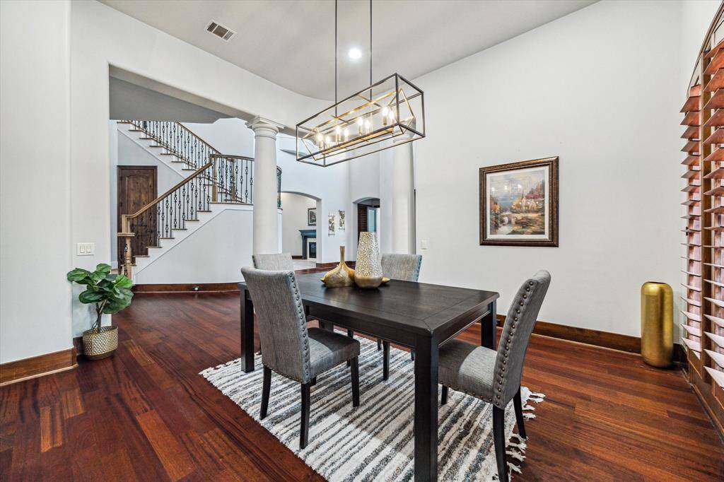 The formal dining room is an ideal setting for hosting family dinners, featuring elegant design elements that create a warm and inviting atmosphere for gatherings.