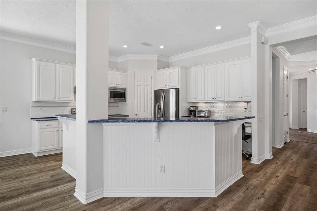 Kitchen with all new stainless appliances, new counters, freshly painted throughout. Pantry next to the refrigerator.
