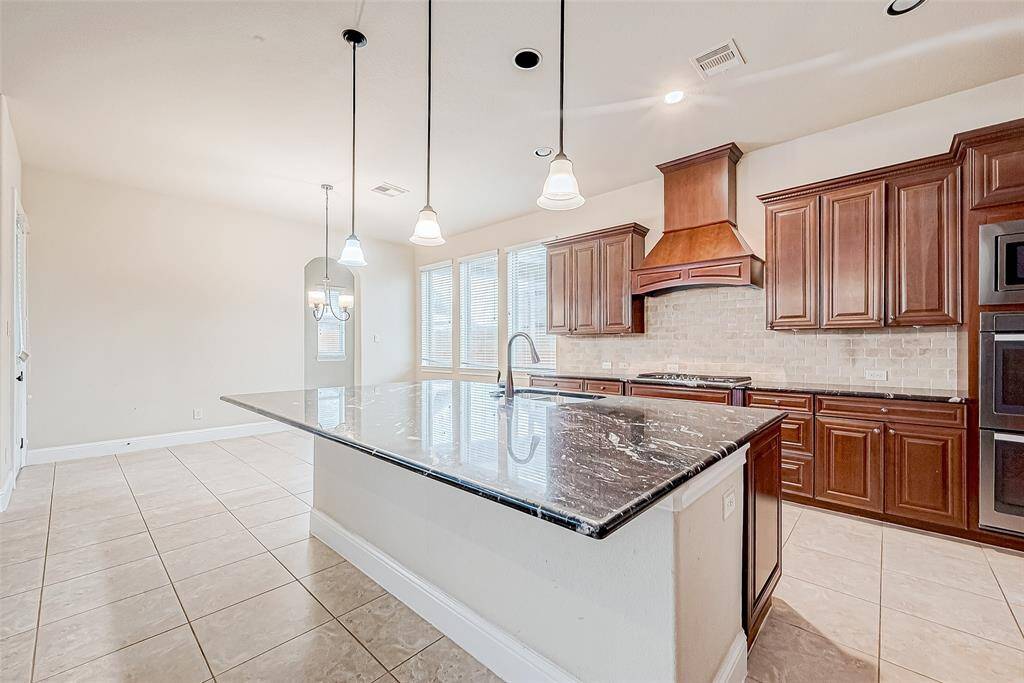 The room features ample natural light and a neutral tile floor, creating a warm and inviting atmosphere.